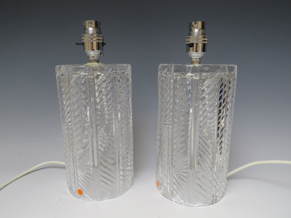 A PAIR OF WATERFORD CRYSTAL GLASS TABLE LAMPS. of cylindrical form, lamp H 20 cm, overall H 26 cm,