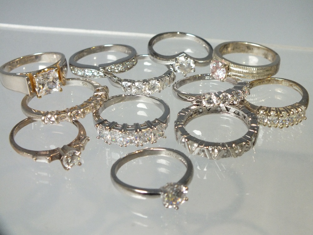 A COLLECTION OF TWELVE SILVER AND CZ DRESS RINGS, mostly QVC Diamonique examples. various designs