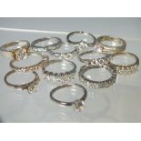 A COLLECTION OF TWELVE SILVER AND CZ DRESS RINGS, mostly QVC Diamonique examples. various designs