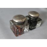 A PAIR OF VINTAGE NAZI GLASS INK WELLS the hinged white metal tops having engraved swastika and