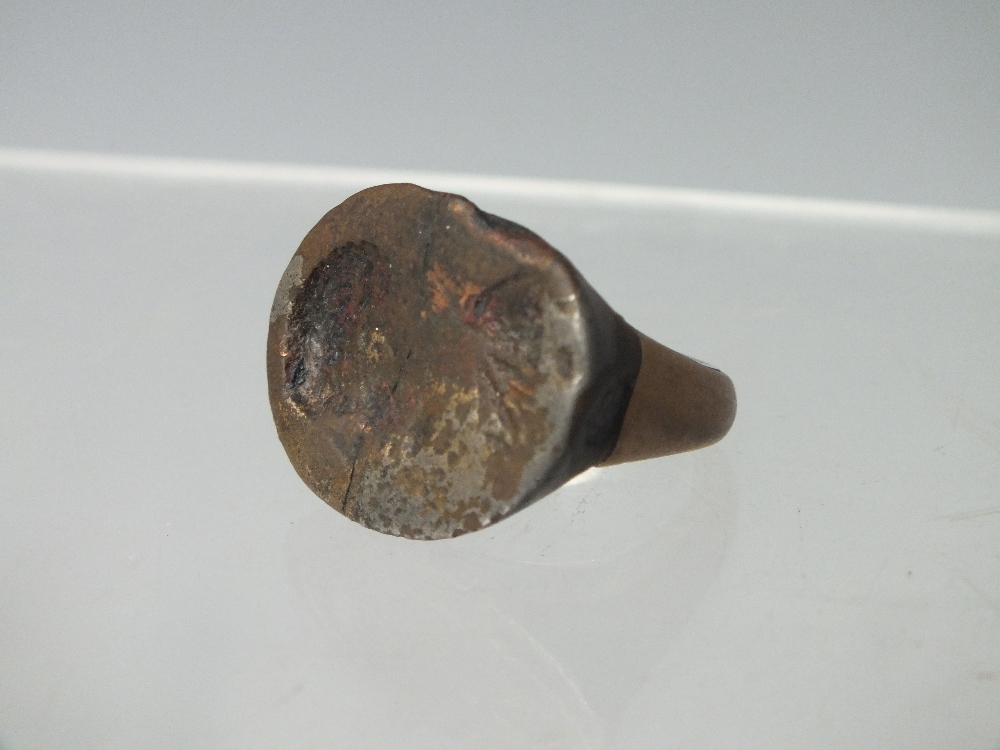 A BRONZE ROMAN HEAD SEAL RING TOP, on later brass ring with additional white metal insert