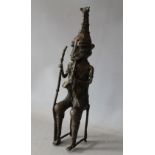 A 20TH CENTURY BENIN STYLE METAL STUDY OF A SEATED TRIBESMAN WITH MUSICAL INSTRUMENT, H 31 cm