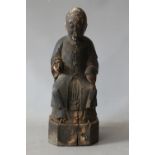 A LATE 18TH / EARLY 19TH CENTURY ORIENTAL SEATED HOLY MAN, with pouch in recess at rear, H 27 cm