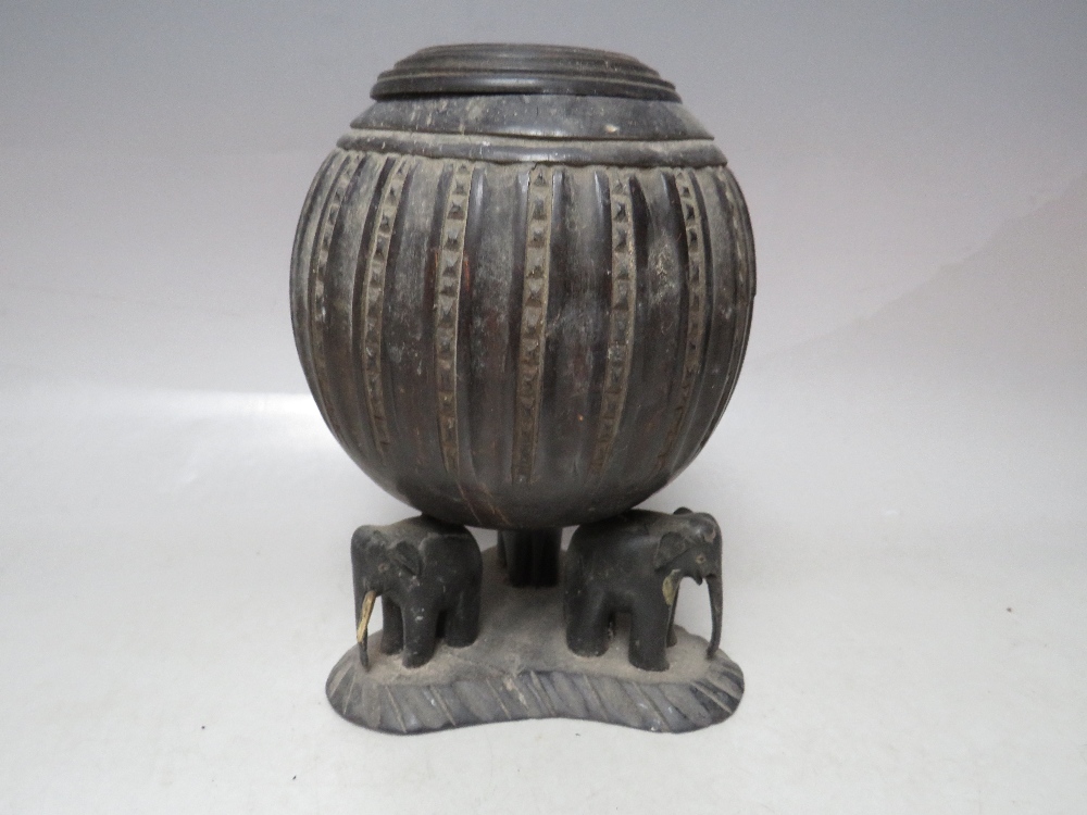 A 19TH CENTURY CARVED COCONUT SHELL AND LID, raised on a white metal covered support, H 23 cm, - Image 5 of 10