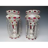 A PAIR OF LATE 19TH CENTURY BOHEMIAN GLASS LUSTRES, white overlay on cranberry glass, extensive