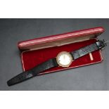 GARRARD - A GENTS MANUAL WIND WRIST WATCH, probably 9 carat gold, 25yr service inscription dated