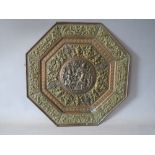 AN OCTAGONAL ORIENTAL METAL WALL PLAQUE WITH RELIEF EMBELLISHMENT, the profuse embellishment