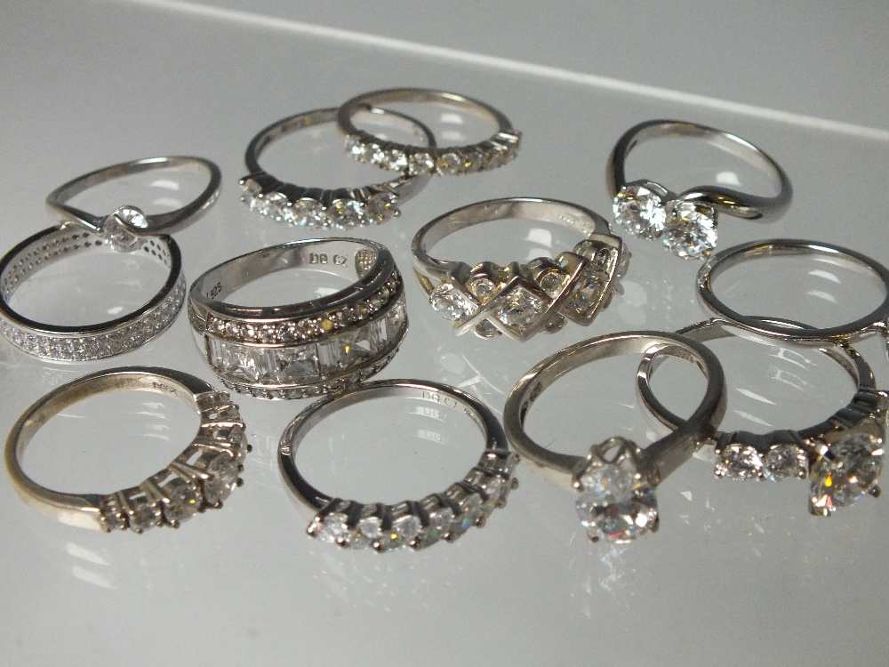 A COLLECTION OF TWELVE SILVER AND CZ DRESS RINGS, mostly QVC Diamonique examples. various designs