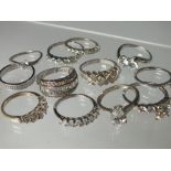A COLLECTION OF TWELVE SILVER AND CZ DRESS RINGS, mostly QVC Diamonique examples. various designs
