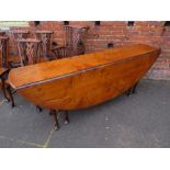 A LARGE STEWART LINFORD BESPOKE BURR ELM AND YEW OVAL DROPLEAF TABLE, with typical gateleg