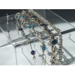 THREE MODERN SILVER GEMSET BRACELETS, to include a diamante set tennis bracelet, together with an