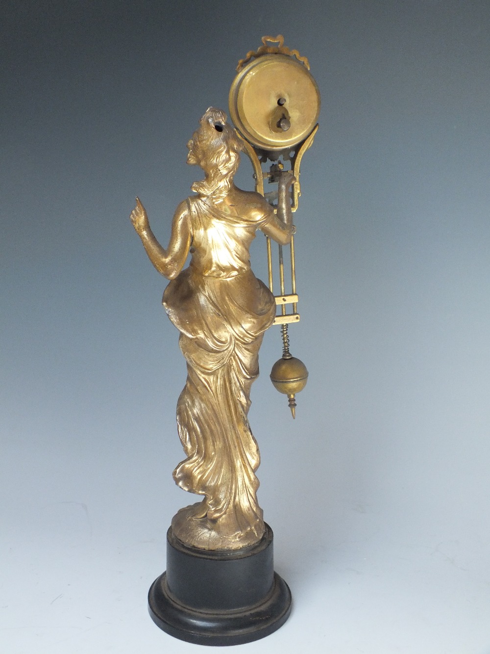 AN ART NOUVEAU FEMALE FIGURAL MYSTERY CLOCK, the gilded spelter figure with arm outstretched - Image 2 of 4