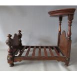 A VINTAGE CARVED WOODEN HALF TESTER STYLE MINIATURE / DOLLS BED, L 49 cm, H 43 cm x W 32.5 cm