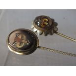 A VICTORIAN REVERSE PAINTED OVAL GLASS FOX MASK STICK PIN, with opalescent back, in unmarked
