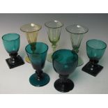 A COLLECTION OF ANTIQUE DRINKING GLASSES, mainly green examples, to include a single apple green