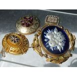 FOUR ANTIQUE MOURNING BROOCHES, varying styles and designs, to include a Victorian large yellow