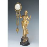 AN ART NOUVEAU FEMALE FIGURAL MYSTERY CLOCK, the gilded spelter figure with arm outstretched