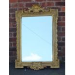 A MID 20TH CENTURY GILT RECTANGULAR WALL MIRROR, with scrolling shell moulded surmount, overall