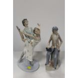 A LARGE NAO FIGURE OF A DANCING COUPLE TOGETHER WITH A CASADES FIGURE OF A SCHOLAR HOLDING A BOOK