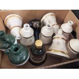 A BOX OF WADE WHISKY BOTTLES AND JUGS