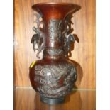 AN ORIENTAL BRONZE STYLE TWIN HANDLED VASE WITH CRANE AND DRAGON DETAIL H - 29.5CM