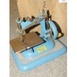 A VINTAGE VULCAN MINIATURE SEWING MACHINE IN WOODEN BOX A/F