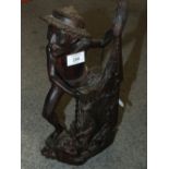 A CARVED HARD WOOD FIGURE OF A FISHERMAN WITH A NET OF FISH H - 40CM