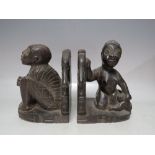 A PAIR OF EBONISED TRIBAL FIGURATIVE BOOKENDS, each modelled with seated figures, H 19 cm (2)