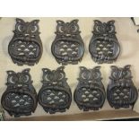 A COLLECTION OF SEVEN CAST METAL OWL SHAPED DOOR KNOCKERS