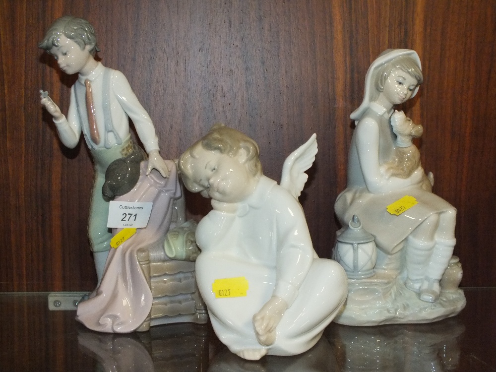 THREE LARGE LLADRO FIGURES COMPRISING OF A BOY WITH A CROSS, A SEATED CHERUB AND A SEATED LADY