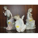 THREE LARGE LLADRO FIGURES COMPRISING OF A BOY WITH A CROSS, A SEATED CHERUB AND A SEATED LADY