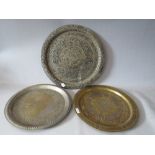 AN ANGLO INDIAN CIRCULAR METAL TRAY EMBELLISHED WITH ISLAMIC SCRIPT, Dia. 34 cm, together with two