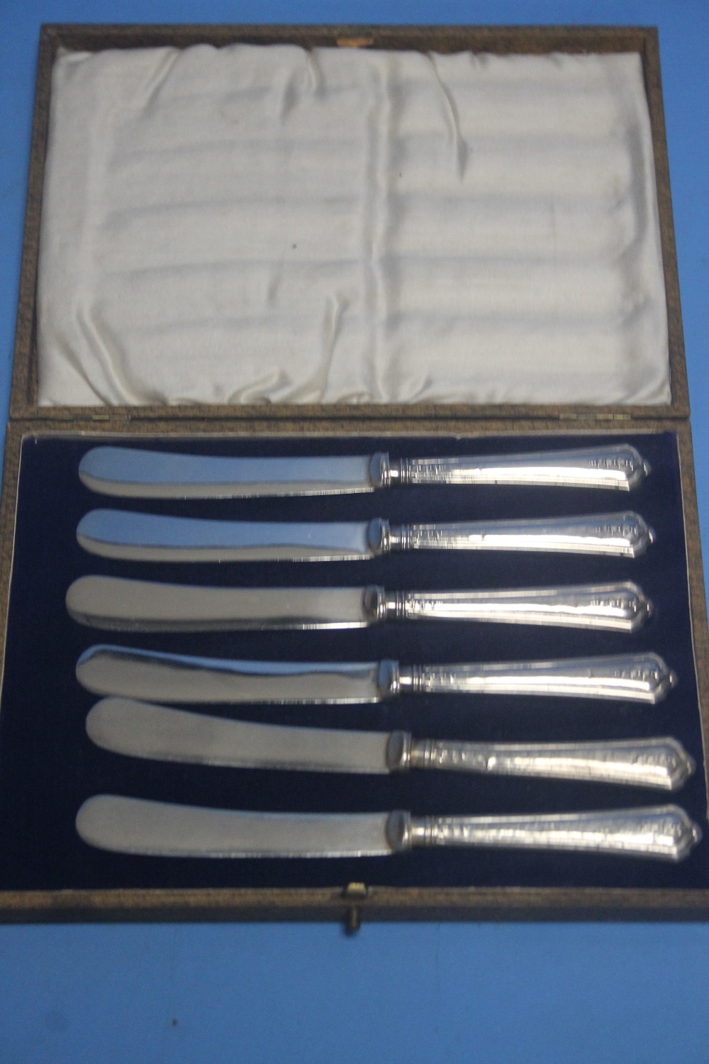 A CASED SET OF SIX HALLMARKED SILVER KNIVES