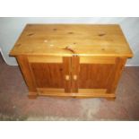 A SOLID PINE LOW CUPBOARD