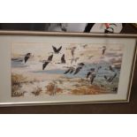 A TAPESTRY PICTURE OF CANADIAN GEESE ALONG WITH A FIRESCREEN