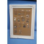 A PICTURE FRAME CONTAINING 14 ITEMS OF SILVER JEWELLERY