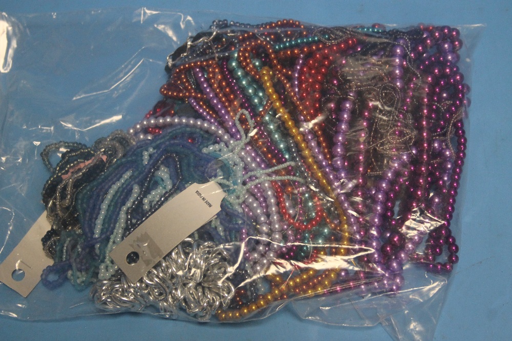 A BAG OF COLOURED BEAD NECKLACES