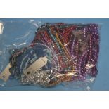 A BAG OF COLOURED BEAD NECKLACES
