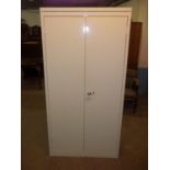 A STRONG STEEL TWO DOOR SHELVED STORAGE CABINET