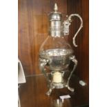 A CLARET JUG ON WHITE METAL STAND