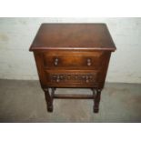 AN OAK TWO DRAWER SIDE CUPBOARD