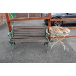 A CAST METAL ENDED GARDEN BENCH TOGETHER WITH A METAL GARDEN TABLE A/F