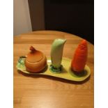 A CARLTONWARE NOVELTY CRUET MODELLED AS CARROT, ONIONS AND PEA POD ON A CORN ON THE COB