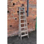 A SET OF VINTAGE WOODEN LADDERS