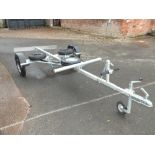 A BOAT TRAILER WITH LAUNCHING WHEELS