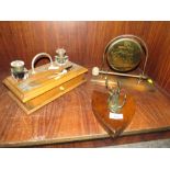 AN OAK TWIN INKWELL DESK STAND TOGETHER WITH A TABLE GONG AND A STAG MOUNTED SHIELD (3)