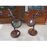 A PAIR OF MODERN REPRODUCTION ADJUSTABLE MAGNIFYING GLASS STANDS