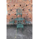 A GREEN CAST ALUMINIUM GARDEN TABLE AND FOUR CHAIRS