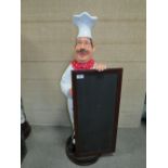 A SHOP DISPLAY CHEF HOLDING A CHALKBOARD - H 100 CM