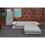 AN ITALIAN 'ROCH BOBOIS' CREAM LEATHER THREE SEATER SETTEE AND MATCHING FOOTSTOOL, WITH SPARE SEAT